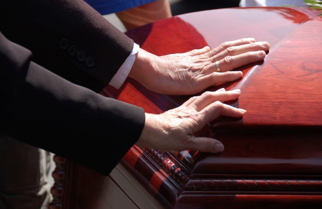 hand on casket